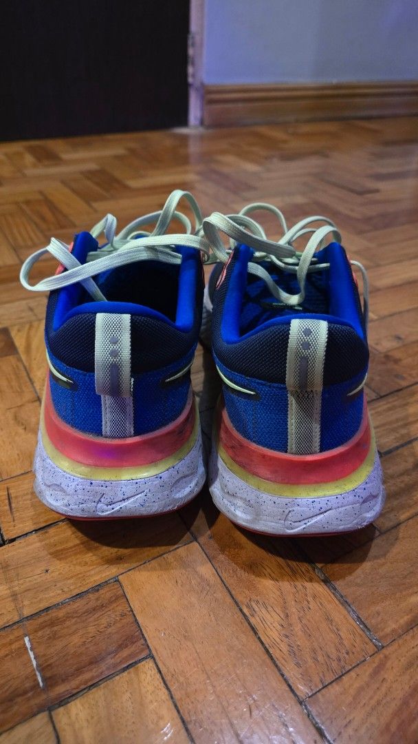 Nike React Infinity Run Flyknit Running Shoes (Category: Sneakers) located in Pasig City. Submitted by johnflan (Listing ID 1467343355, Image 2). Description: - Brand: Nike - Model: React Infinity Run Flyknit - Colorway: Blue and black knit upper with vibrant neon yellow laces and multicolored midsole accents - Sole: Cushioned React foam with textured tread for great grip - Special Detail: 'RUN PAST THE FUTURE' graphic print on the insoles - Cond