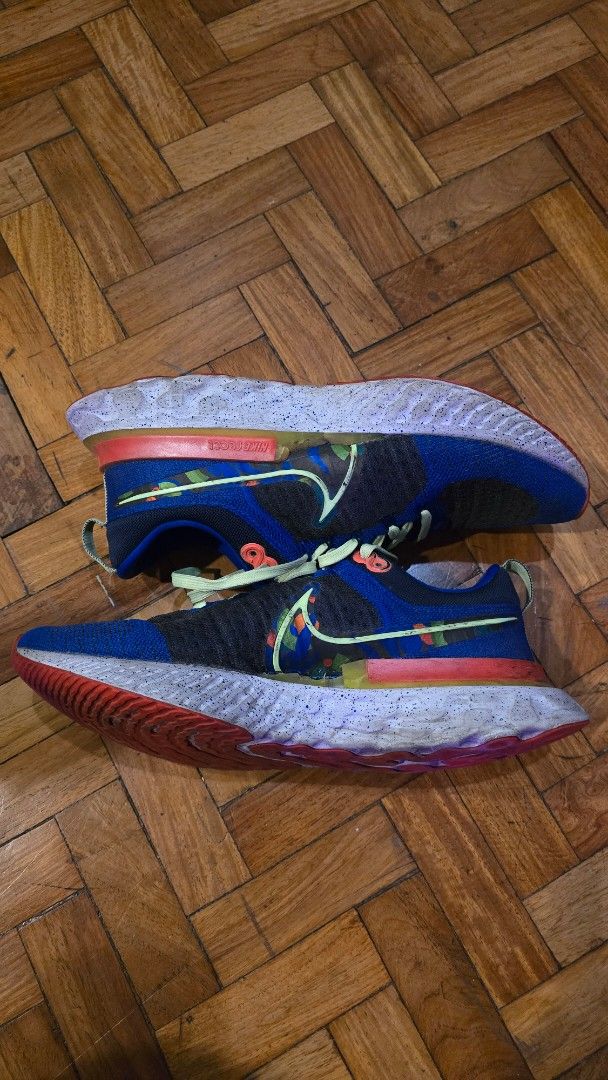 Nike React Infinity Run Flyknit Running Shoes (Category: Sneakers) located in Pasig City. Submitted by johnflan (Listing ID 1467343355, Image 1). Description: - Brand: Nike - Model: React Infinity Run Flyknit - Colorway: Blue and black knit upper with vibrant neon yellow laces and multicolored midsole accents - Sole: Cushioned React foam with textured tread for great grip - Special Detail: 'RUN PAST THE FUTURE' graphic print on the insoles - Cond