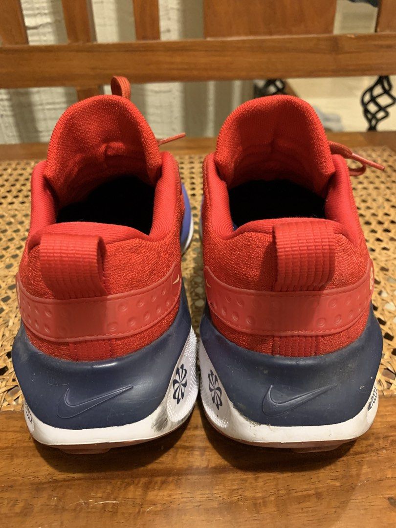 Nike ReactX Infinity Run 4 Red Blue Running Shoes (Category: Sneakers) located in Makati City. Submitted by movingpeach (Listing ID 1467232923, Image 3). Description: Nike ReactX Infinity Run 4 sneakers in red, navy blue, and white. Flyknit upper with classic lace-up closure. Cushioned ReactX midsole provides a smooth ride. Dark swoosh branding on the side. Some scuff marks on the white sole near the heel area from previous wear, otherwise clean 