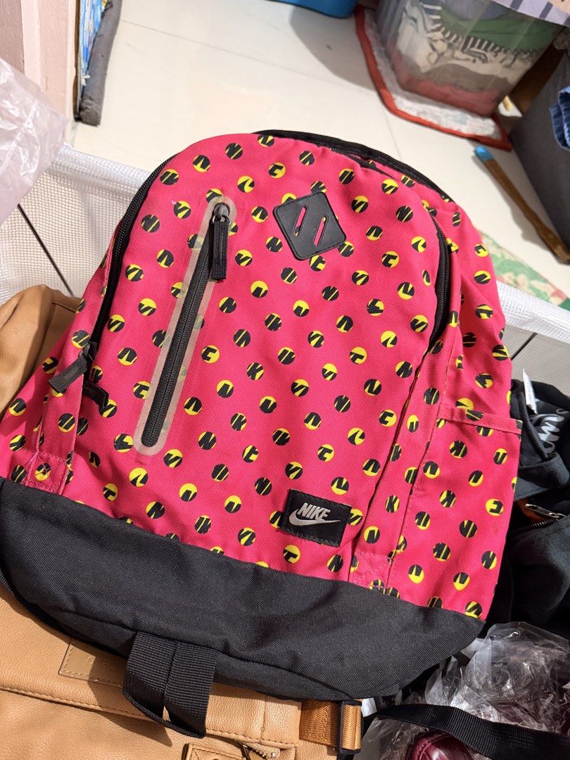 Nike Small Cheyenne Print Backpack Pink Yellow (Category: Backpacks) located in Quezon City. Submitted by kym.a (Listing ID 1467349864, Image 1). Description: - Brand: Nike (Model BA5223 616) - Color/Pattern: Vibrant pink with yellow and black dot pattern, paired with a black bottom panel and back straps - Material: 100% durable polyester - Pockets: Front vertical zip pocket with branding patch and tag, plus an internal mesh zip pocket in the mai