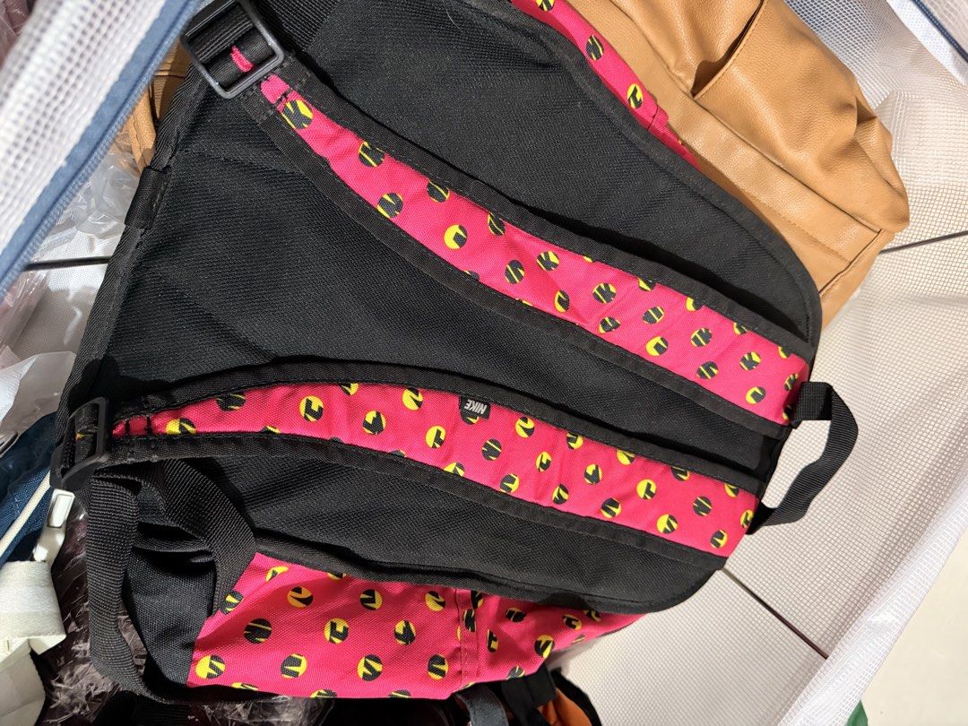 Nike Small Cheyenne Print Backpack Pink Yellow (Category: Backpacks) located in Quezon City. Submitted by kym.a (Listing ID 1467349864, Image 2). Description: - Brand: Nike (Model BA5223 616) - Color/Pattern: Vibrant pink with yellow and black dot pattern, paired with a black bottom panel and back straps - Material: 100% durable polyester - Pockets: Front vertical zip pocket with branding patch and tag, plus an internal mesh zip pocket in the mai
