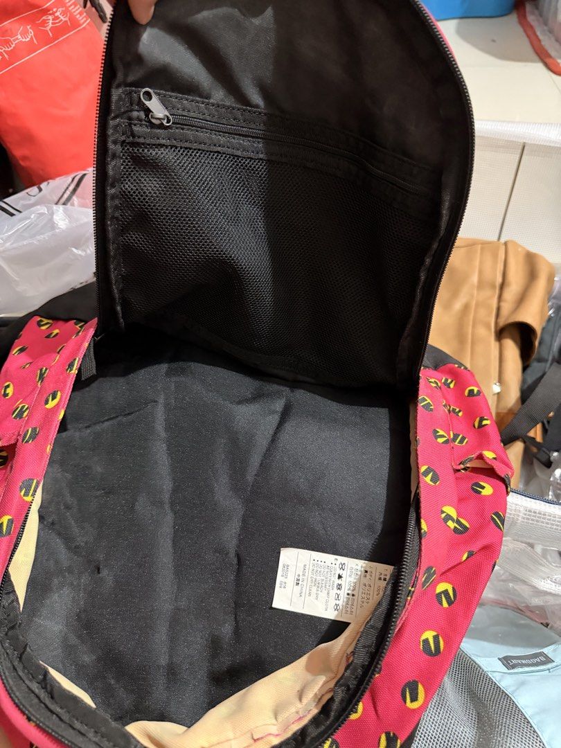 Nike Small Cheyenne Print Backpack Pink Yellow (Category: Backpacks) located in Quezon City. Submitted by kym.a (Listing ID 1467349864, Image 3). Description: - Brand: Nike (Model BA5223 616) - Color/Pattern: Vibrant pink with yellow and black dot pattern, paired with a black bottom panel and back straps - Material: 100% durable polyester - Pockets: Front vertical zip pocket with branding patch and tag, plus an internal mesh zip pocket in the mai