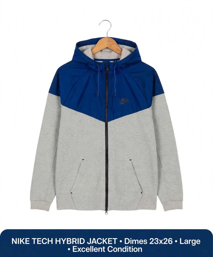 NIKE TECH HYBRID JACKET Blue Grey Size Large (Category: Coats, Jackets and Outerwear) located in Lucena. Submitted by jestonioab55753 (Listing ID 1467294922, Image 1). Description: - Brand: Nike Tech Hybrid Jacket - Color: Blue and Grey (Two-tone colorblock paneling) - Size: Large (Measures 23" pit-to-pit by 26" length) - Closure: Full zip front with dual-zip design - Hood: Attached hood with adjustable drawstrings - Pockets: Secure front pockets
