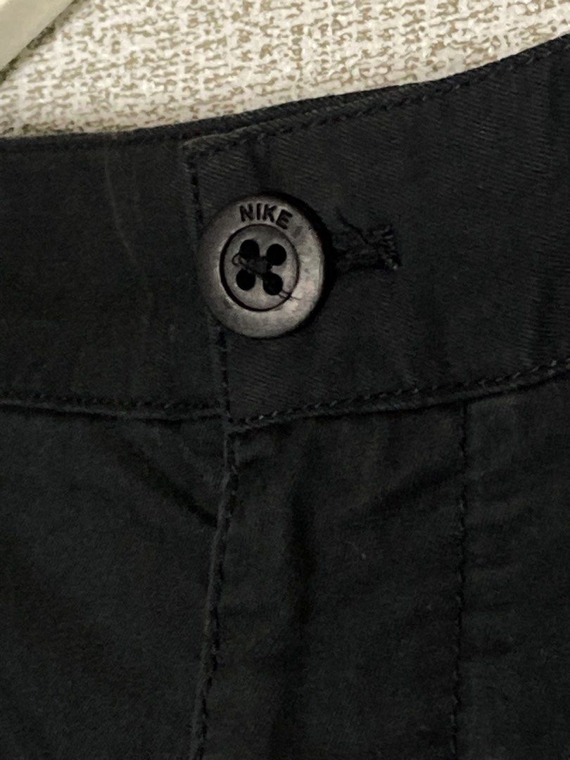 Nike The Athletic Dept Black Chino Pants (Category: Trousers) located in Baguio. Submitted by drip_n_drop (Listing ID 1467325149, Image 3). Description: - Color: Black - Closure: Button closure with zipper fly - Branding: Embroidered Nike swoosh on front left leg and small 'the athletic dept.' patch on back right pocket - Pockets: Two front pockets and two back welt pockets - Style: Versatile and comfortable for casual wear or everyday outfits.