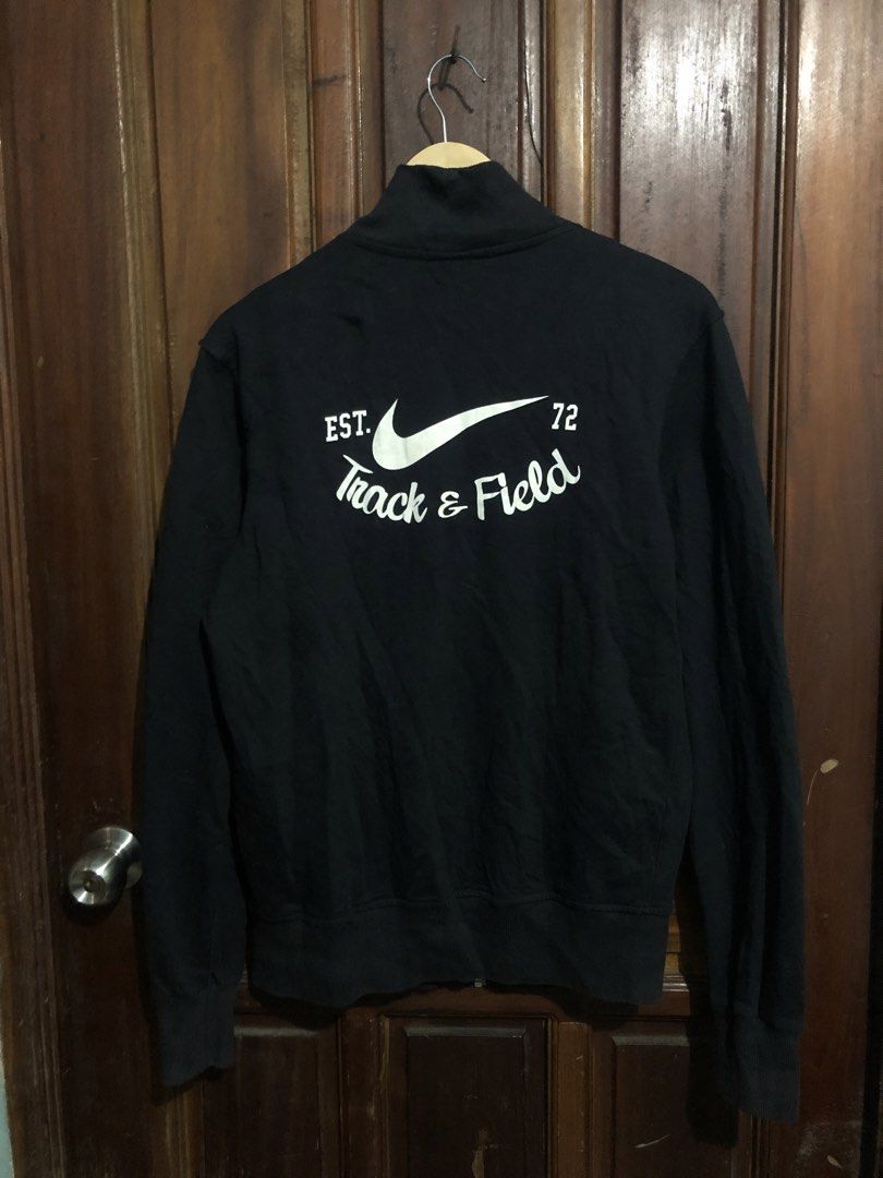 Nike The Athletic Dept Track & Field Zip Jacket (Category: Coats, Jackets and Outerwear) located in Quezon City. Submitted by yeahsource222 (Listing ID 1467241890, Image 2). Description: - Brand: Nike - Type: Full-zip jacket - Color: Black - Size: Medium - Details: Orange Athletic Dept tag, small front swoosh, large back swoosh with 'Track & Field EST. 72' graphic - Material: Comfortable cotton blend - Condition: Good - Best for: Casual wear or t