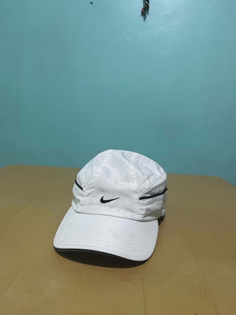 Nike White Nylon Cap with Drawstring Back (Category: Caps & Hats) located in Lapu Lapu. Submitted by trip-thrift (Listing ID 1467287949, Image 1). Description: - Brand: Nike - Color: White with black embroidered swoosh logo (front and back) - Material: Lightweight nylon - Fit: Adjustable black drawstring cord at the back - Brim: Solid white curved brim - Flaw: Faint yellowish discoloration along the inside sweatband area.