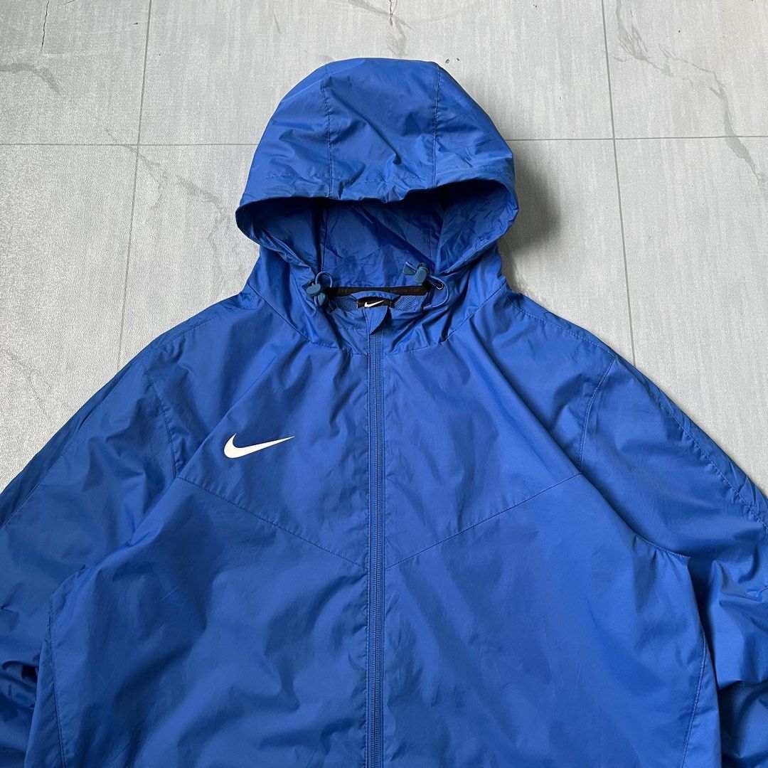 Nike Windbreaker Jacket (Authentic) (Category: Coats, Jackets and Outerwear) located in Cavite. Submitted by newclassicwear (Listing ID 1467357957, Image 3). Description: Size L On Tag (23width 28length) Excellent Condition 9.8 Honest Color Rate None Any Issue Can Do Meet Up Around Sm Tanza Cavite Tanza📍 Vibrant blue Nike windbreaker with matching hood and drawstrings. Full front zip closure and dual zippered side pockets. Lightweight material, 
