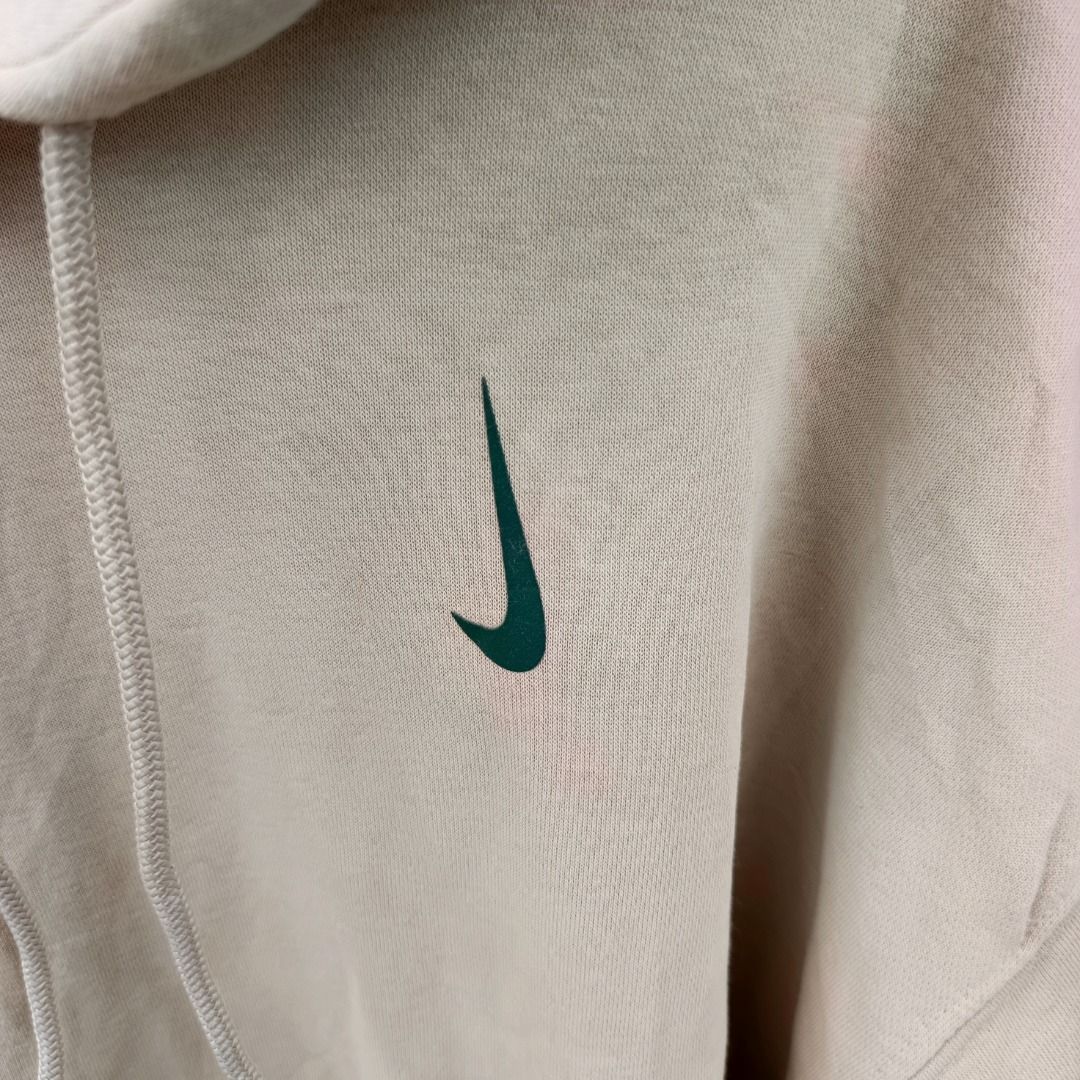 Nike x Billie Eilish Hoodie jacket (Category: Hoodies) located in Caloocan City. Submitted by evancaindo28330 (Listing ID 1467311708, Image 3). Description: - Brand: Nike - Color: Beige with embroidered green swoosh - Size: Medium (Standard Fit) - Material: Soft fleece interior, made in Pakistan - Features: Adjustable hood drawstrings and front kangaroo pocket - Condition: Clean overall look, great for casual styling.