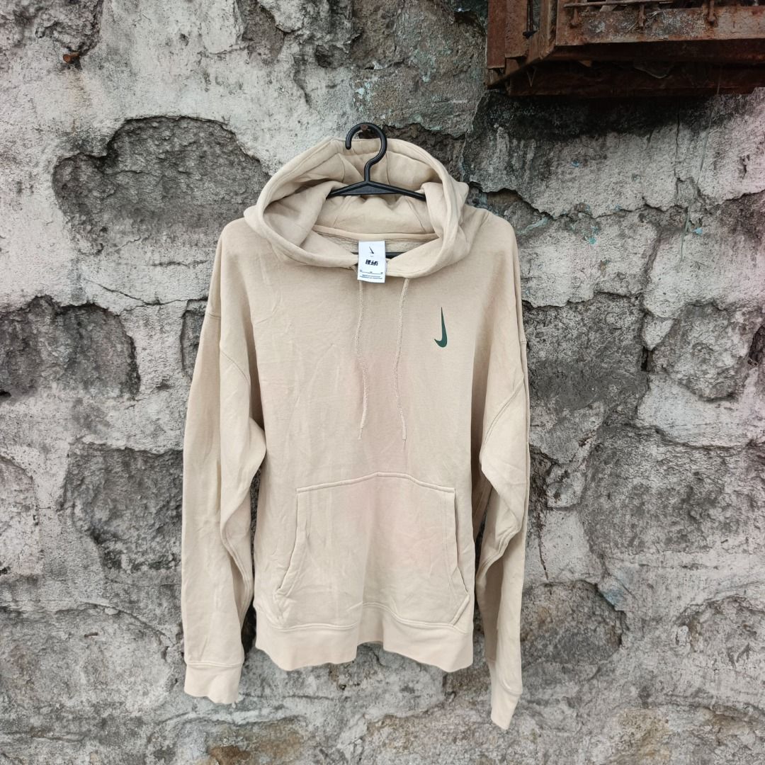 Nike x Billie Eilish Hoodie jacket (Category: Hoodies) located in Caloocan City. Submitted by evancaindo28330 (Listing ID 1467311708, Image 1). Description: - Brand: Nike - Color: Beige with embroidered green swoosh - Size: Medium (Standard Fit) - Material: Soft fleece interior, made in Pakistan - Features: Adjustable hood drawstrings and front kangaroo pocket - Condition: Clean overall look, great for casual styling.