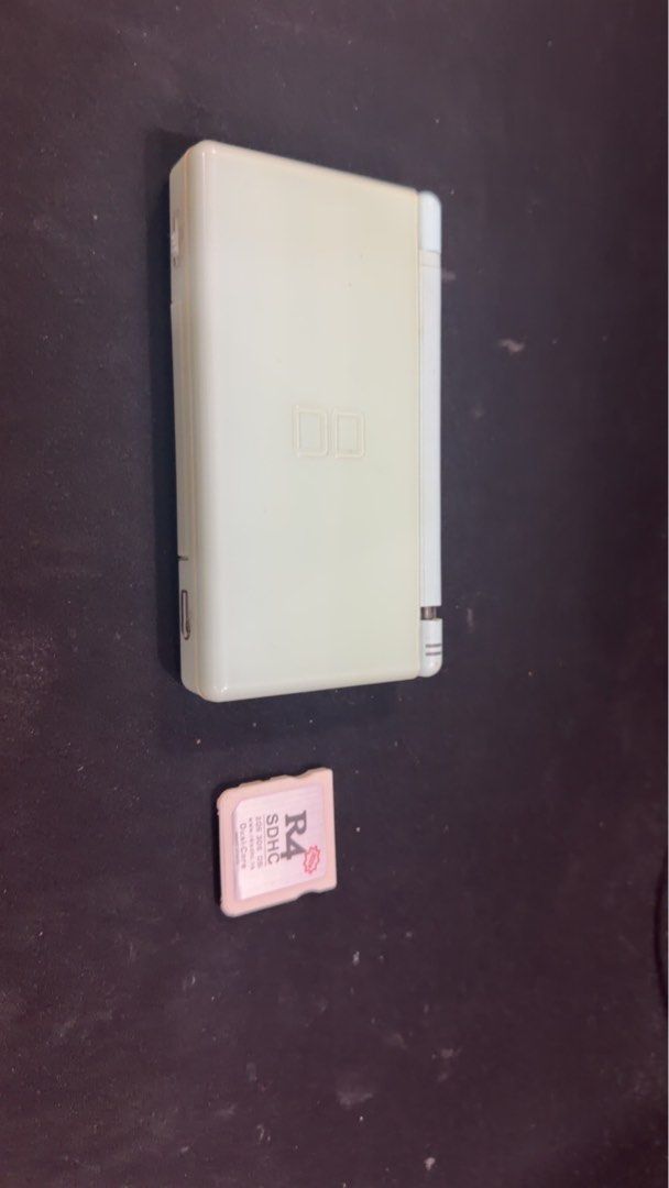 Nintendo DS Lite White with R4 SDHC Card (Category: Nintendo) located in Taguig. Submitted by albanians (Listing ID 1467244112, Image 1). Description: - Color: Teal - Condition: Signs of yellowing in the outer shell, charges normally, one hinge is broken but easily repairable - Screen is in good condition considering its age - Includes: Stylus and R4 SDHC 32GB worth Php 750 card for downloaded games - Perfect retro handheld for travel or daily pl