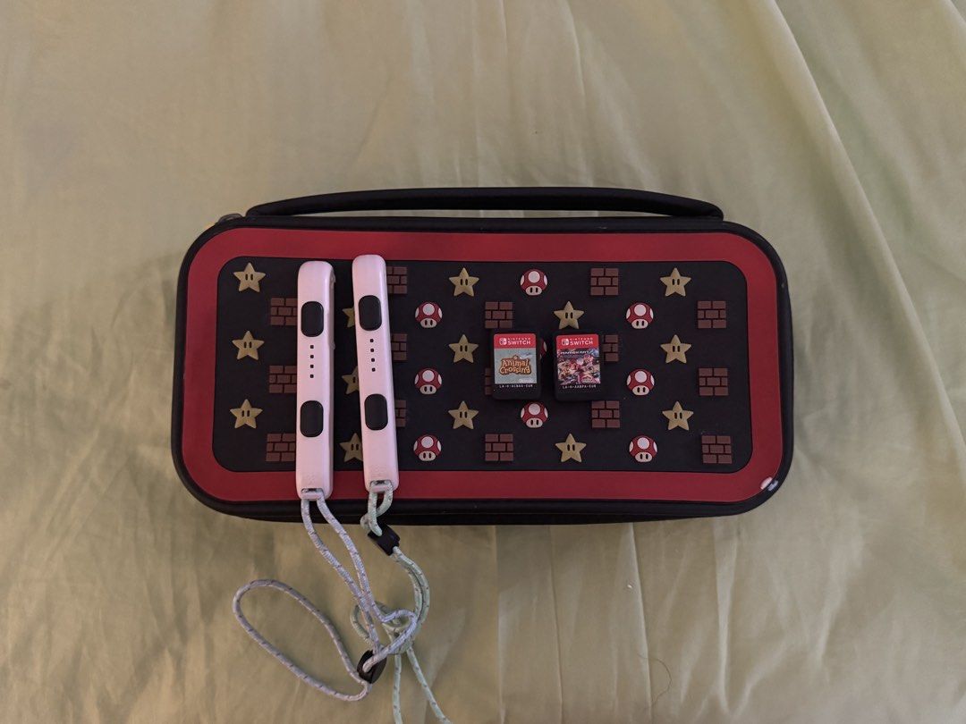 Nintendo Switch console bundle with Mario carrying case and games (Category: Nintendo) located in Manila. Submitted by mavelaa (Listing ID 1467172008, Image 3). Description: Comes with 2 SD cards and 1 online card (from nintendo e-shop) - Animal Crossing -Mario Kart - Tomodachi Life (Nintendo e-shop) Doesn't come with the TV Dock anymore ‼️ Price is still negotiable - STRICTLY payment first.