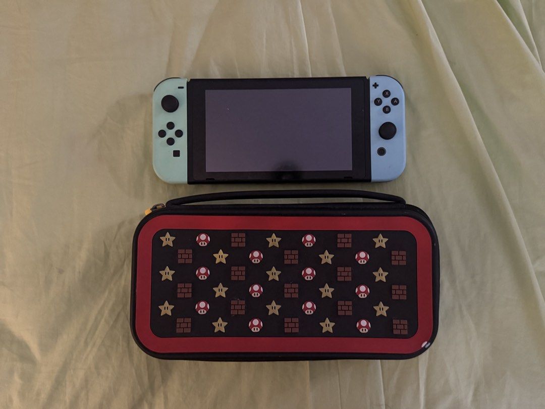 Nintendo Switch console bundle with Mario carrying case and games (Category: Nintendo) located in Manila. Submitted by mavelaa (Listing ID 1467172008, Image 2). Description: Comes with 2 SD cards and 1 online card (from nintendo e-shop) - Animal Crossing -Mario Kart - Tomodachi Life (Nintendo e-shop) Doesn't come with the TV Dock anymore ‼️ Price is still negotiable - STRICTLY payment first.