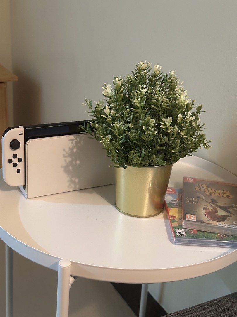 Nintendo Switch OLED Model White with Games (Category: Nintendo) located in Cainta. Submitted by deescloset__ (Listing ID 1467357114, Image 1). Description: - Item: Nintendo Switch OLED Console (White dock and matching Joy-Cons) - Condition: Adult-owned, adult-played, and very clean setup - Games: Includes physical game cartridges stacked neatly, featuring It Takes Two, Mario Kart, Animal Crossing, and Little Nightmares - Reason for selling: Upgr