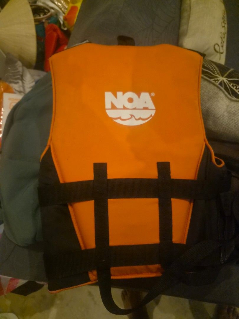 NOA Medium Life Jacket (Category: Water Sports) located in Muntinlupa City. Submitted by chubby_daddy82 (Listing ID 1467277486, Image 2). Description: - Brand: NOA Floatation Aid / Type III PFD - Size: Medium - Color: High-visibility orange and black with reflective stripes - Fit: Three adjustable quick-release buckle straps - Safety: Printed safety warnings and care instructions inside - Usage: Perfect for water sports and recreational boating.