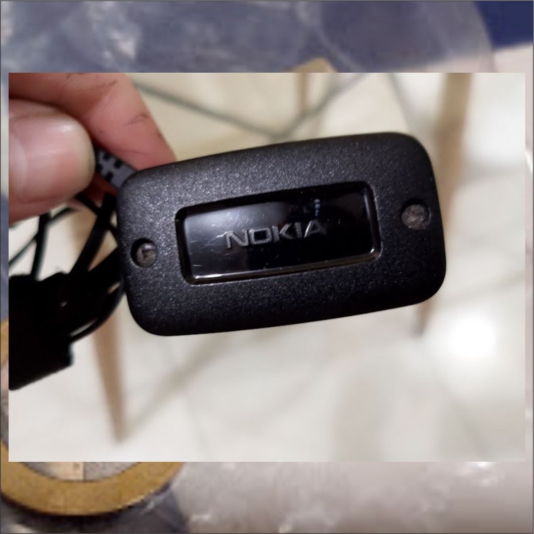 Nokia AC Wall Charger Power Adapter (Category: Chargers) located in Quezon City. Submitted by susmaryosep1 (Listing ID 1467269197, Image 3). Description: - Authentic original Nokia wall charger - Features a thin barrel connector pin and standard US two-prong plug - Comes with an attached black cable, neatly coiled - Includes a reusable velcro strap for easy storage and portability - Ideal backup or replacement power adapter for compatible older N