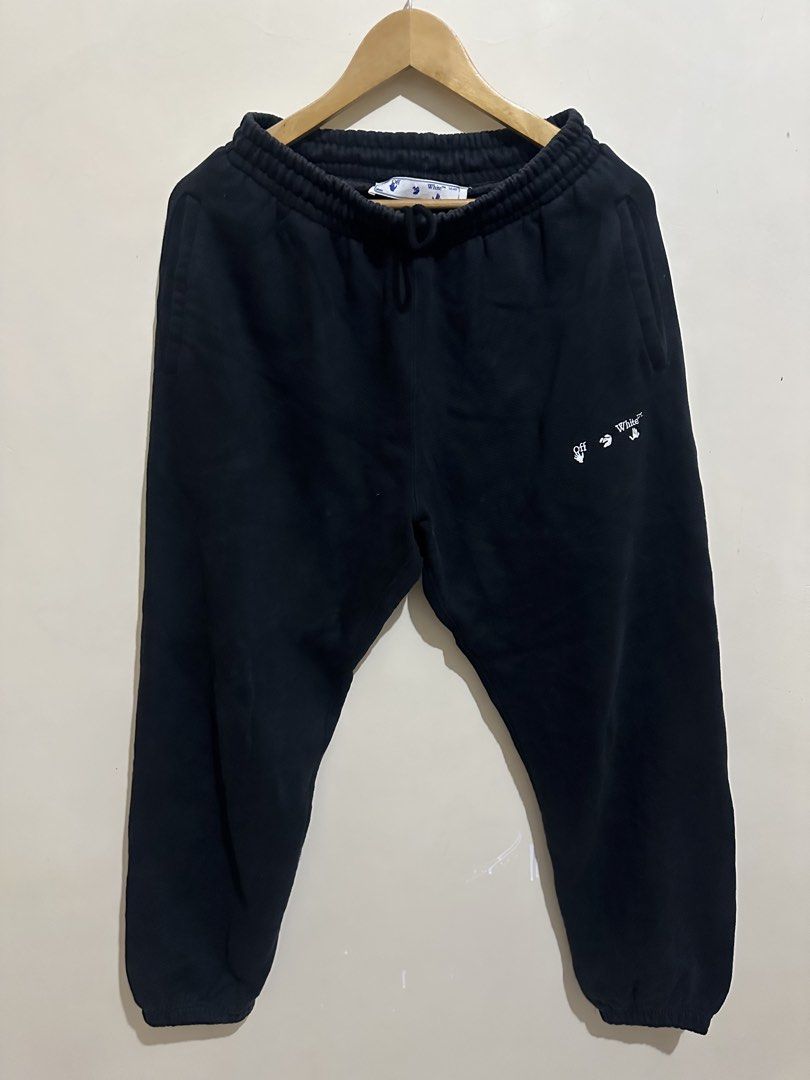 Off-White Black Sweatpants (Category: Joggers) located in Tagum. Submitted by ritarits572 (Listing ID 1467289100, Image 1). Description: - Brand: Off-White - Color: Black - Size: S, 13 x 37 - Material: 100% cotton main fabric with polyester embroidery - Features: Drawstring waist, side pockets, and interior tags attached - Design: Small white logo print near the front pocket and iconic diagonal stripe graphics down the back of both legs.