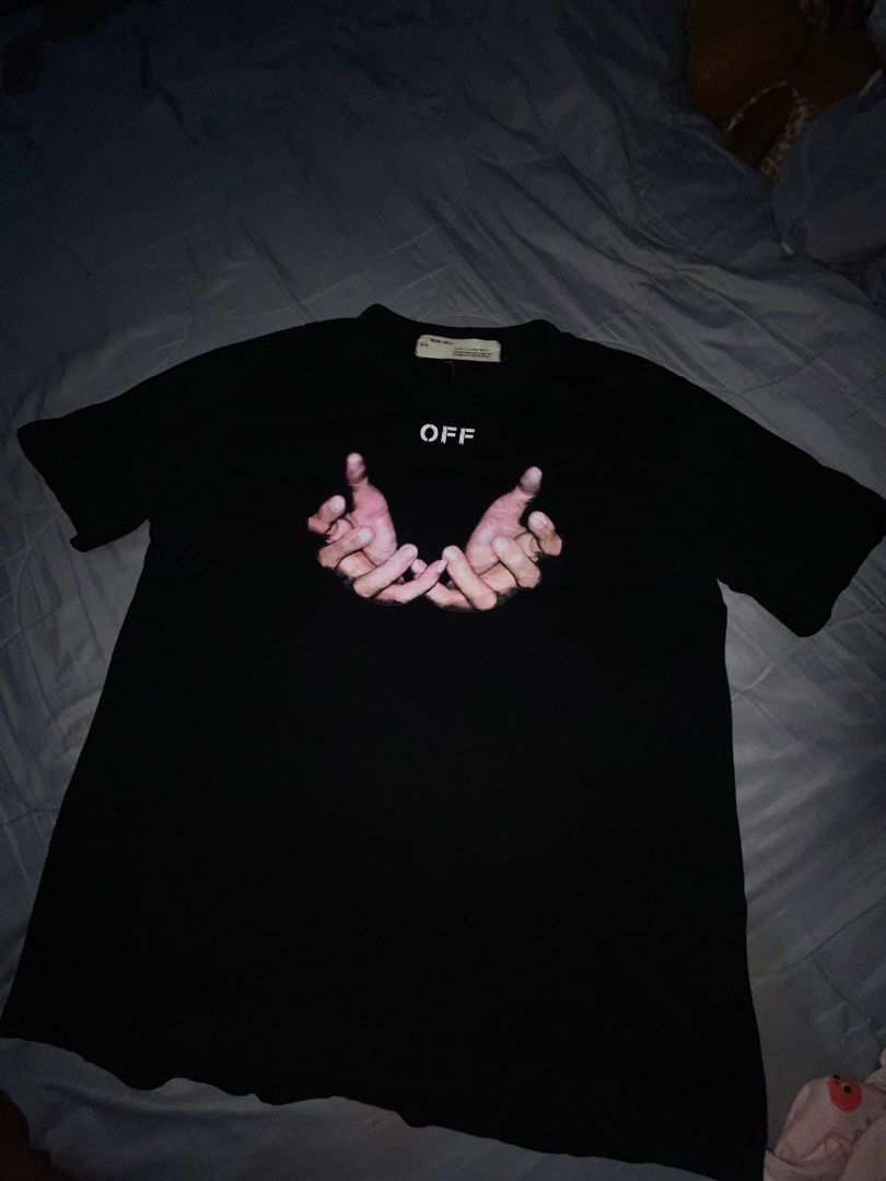 Off-White Hand Graphic Black T-Shirt (Category: Tshirts & Polo Shirts ) located in Cagayan de Oro. Submitted by zekoy (Listing ID 1467275774, Image 1). Description: Authentic Off-White black short-sleeve t-shirt in regular fit. Features hand graphic print on the front and iconic 3D diagonal stripes on the back. Made of comfortable cotton with standard interior neckline branding. Clean condition, ready to wear..