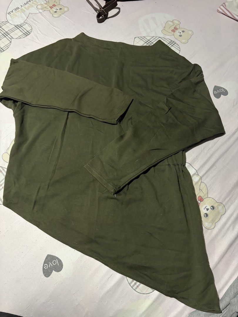 Olive green asymmetric long-sleeve top (Category: Longsleeves) located in Manila. Submitted by mcllts (Listing ID 1467344154, Image 1). Description: - Color: Olive green - Style: Long sleeves, boat neckline, trendy asymmetric hem - Material: Lightweight and comfortable fabric - Versatility: Easy to style with jeans or leggings - Additional Info: Measurements available upon request, drop a message if interested.