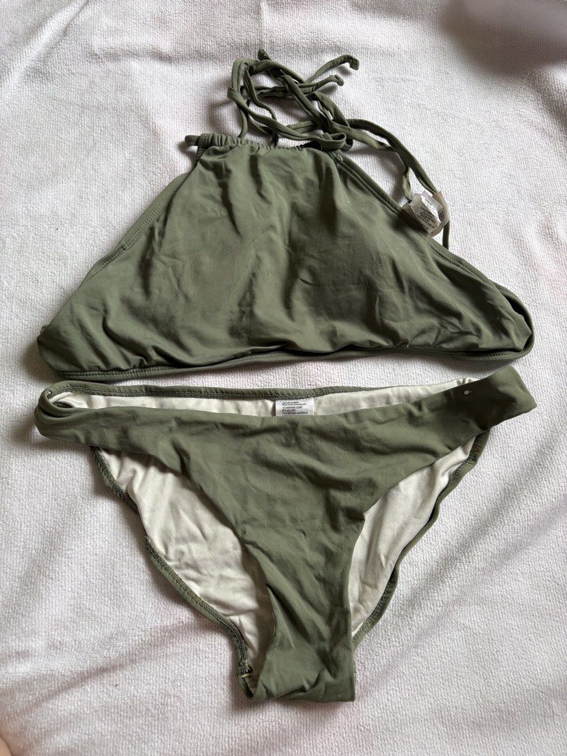 Olive green high neck halter bikini set (Category: Bikinis & Swimsuits) located in Makati City. Submitted by katch2 (Listing ID 1467321774, Image 1). Description: - Brand: Cotton On Body - Item: Olive green bikini set - Size: 14 - Condition: Like new - Top Style: High neck halter with trendy strappy back detail - Bottoms: Matching bottoms featuring comfortable white lining - Perfect for swimming, vacations, and beach days.