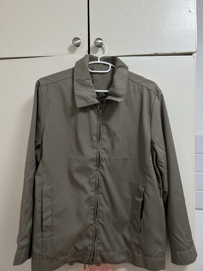 Olive green zip up casual jacket with collar (Category: Coats, Jackets and Outerwear) located in Pateros City. Submitted by safewind_85fc6d (Listing ID 1467324757, Image 1). Description: - Color: Olive green - Closure: Full front zipper - Collar: Classic pointed style - Sleeves: Long sleeves with clean-finish cuffs - Pockets: Two deep side pockets - Style: Simple everyday outerwear, easy to pair with t-shirts and jeans.