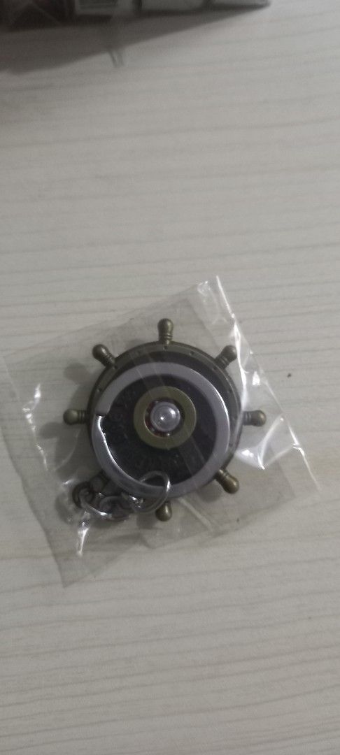 One Piece Luffy Pirate Ship Wheel Keychain (Category: Character Goods) located in Pasig City. Submitted by j-fri0127 (Listing ID 1467176628, Image 2). Description: - Official One Piece design: Ship's steering wheel with Luffy's iconic straw hat skull emblem in the center - Premium look: Detailed metalwork with a stylish antique bronze finish - Brand new: Still sealed in original clear plastic packaging - Versatile: Great for anime merch collector