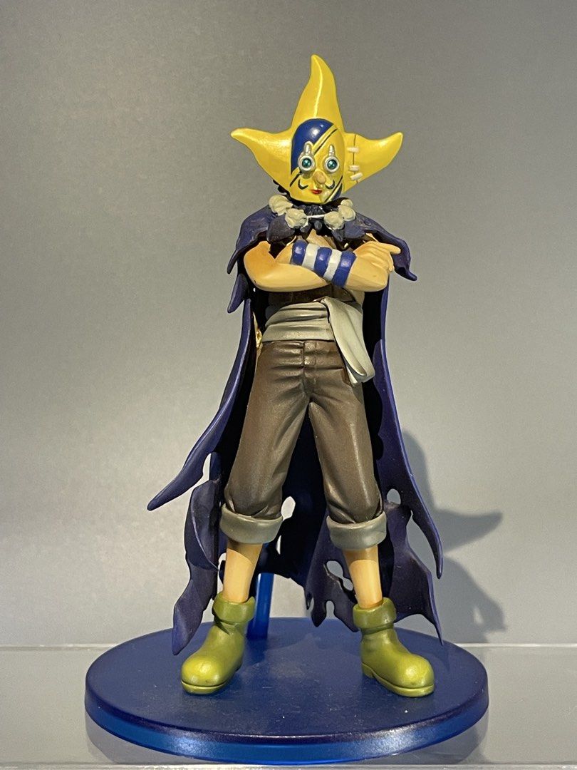 One Piece Sogeking Usopp Figure (Category: Figurines & Statues) located in Calasiao. Submitted by grandshark_635287 (Listing ID 1467300140, Image 1). Description: - Character: Sogeking (One Piece) - Pose: Standing with arms crossed - Features: Iconic yellow star mask and purple cape - Base: Includes round blue display stand - Condition: Brand new / Great addition to any anime collection.
