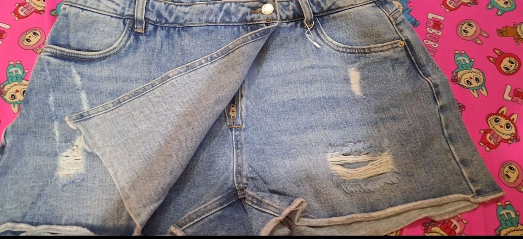 ONLY Distressed Denim Skort Midwash Blue (Category: Skirts) located in Manila. Submitted by katkween23 (Listing ID 1467191297, Image 3). Description: - Color: Midwash blue - Style: Distressed denim skort with asymmetric wrap-over front - Design: Built-in shorts underneath, trendy rips, and frayed hems - Closure: Front button and zip - Perfect for: Casual wear and warm weather.