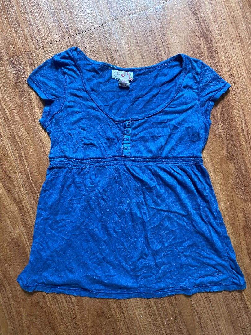 OP Blue Scoop Neck Button Detail Top (Category: Blouses) located in Malasiqui. Submitted by finnley26 (Listing ID 1467240748, Image 1). Description: - Brand: OP - Color: Bright blue - Neckline: Scoop neck with four small front buttons - Sleeves: Short cap sleeves - Waistline: Empire waist with gathered seam - Fit: Lightweight and relaxed - Condition: Worn a few times, washed, and ready to wear.