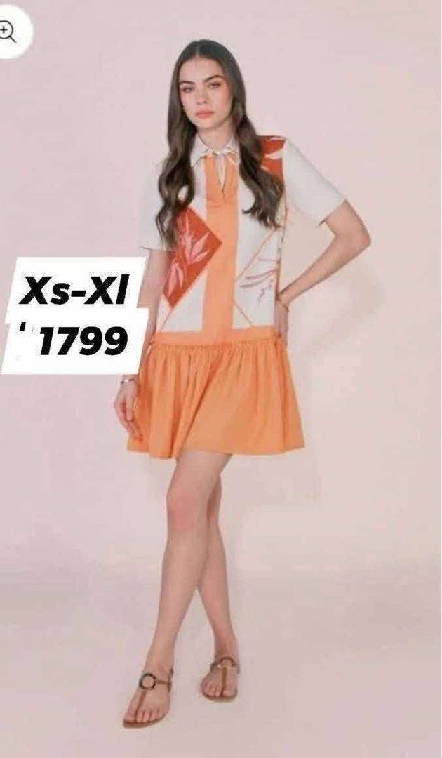 Plains and Prints Dress (Category: Dresses) located in Iba. Submitted by geliqq (Listing ID 1467212400, Image 2). Description: - Style: Casual short-sleeve dress - Design: White and orange panels with red floral graphics on the front - Neckline: Collared with a v-cut placket - Waist & Skirt: Dropped waist with a gathered ruffle skirt - Best for: Everyday wear, easily paired with sandals.