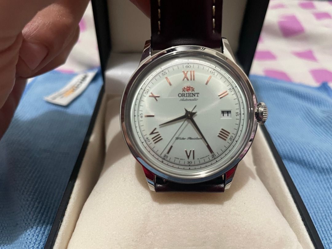 Orient Bambino version 2 (Category: Men's Watches) located in Quezon City. Submitted by charles.argulla (Listing ID 1467353891, Image 1). Description: - Model: Orient Bambino version 2 FAC00008W0 - Dial: White dial with elegant rose gold Roman numerals - Standard size Orient bambino model at 40.5 mm - Inclusions: Complete set with original box and guarantee card. Currently on brown replacement leather strap. Will include the worn out original lea