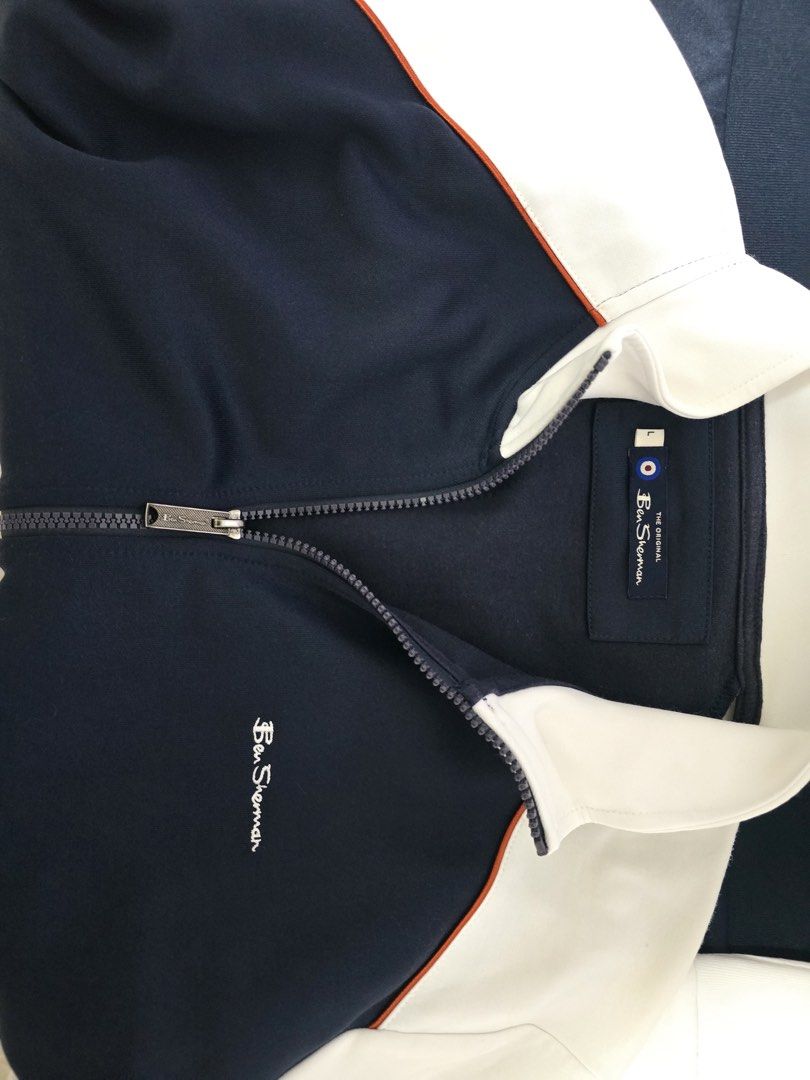 Original Ben Sherman Track Jacket Navy White Size L (Category: Coats, Jackets and Outerwear) located in Manila. Submitted by milleshoppppp (Listing ID 1467337094, Image 3). Description: - Brand: Ben Sherman - Original and Rarely used - Size: L (Tag inside collar) - Bought in US - Color: Navy blue with white sleeves - Details: Full zip with branded metal pull, orange shoulder piping, striped contrast cuffs and hem - Logo: Embroidered Ben Sherman s