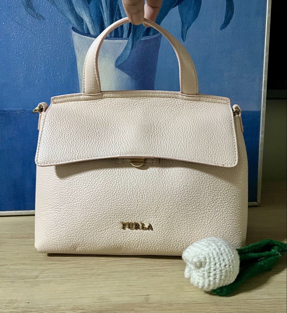 Original Furla sling bag (Category: Cross-body Bags) located in Quezon City. Submitted by madshoppe (Listing ID 1467259127, Image 3). Description: No flaws Light pink in person Small.