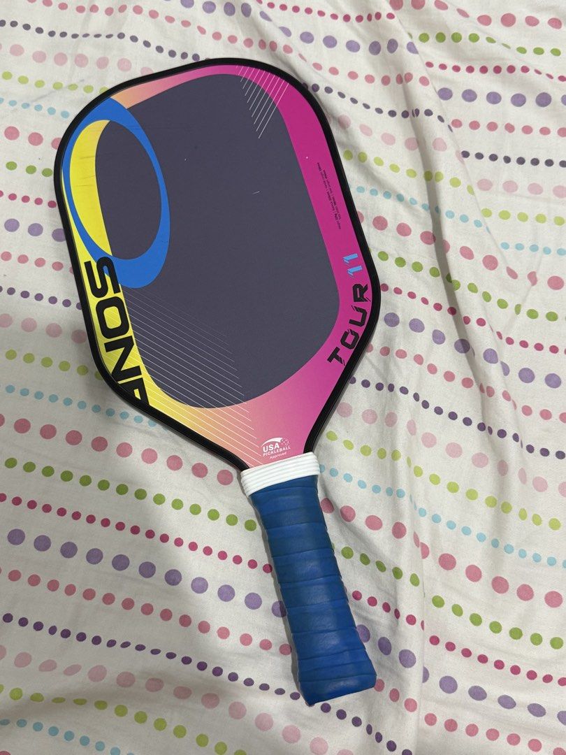 Osone Tour II Pickleball Paddle (Category: Racket and Ball Sports) located in Manila. Submitted by vickie1221 (Listing ID 1467310362, Image 1). Description: • Brand: Osone (Malaysian pickleball brand) • Model: Tour II • Approval: USA Pickleball Approved • Design/Features: Features a vibrant pink, yellow, blue, and black gradient face with a textured surface for spin control, a polypropylene core, and an extended grip handle. • Intended Use: Desig
