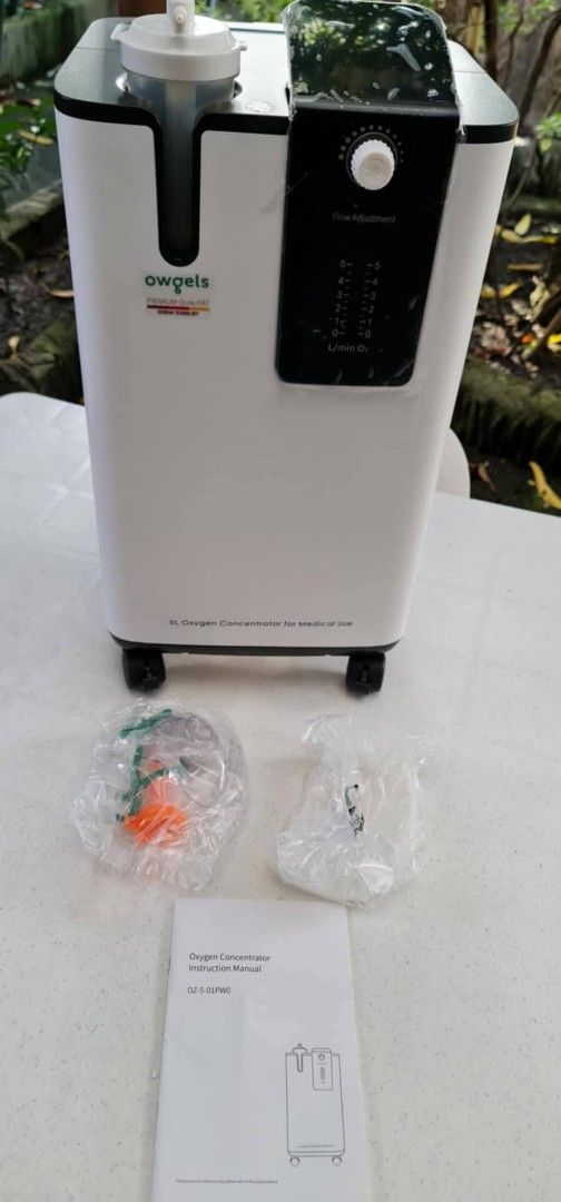 Owgels 5L Oxygen Concentrator OZ-5-01PW0 (Category: Medical Supplies & Tools) located in Las Pinas. Submitted by michtradingandventures (Listing ID 1467237173, Image 1). Description: - Brand: Owgels 5L Medical Oxygen Concentrator - Color/Design: White body with black control panel and flow adjustment dial - Mobility: Mounted on smooth-rolling caster wheels - Inclusions: Humidifier bottle, instruction manual, and sealed accessory packets (tubing a