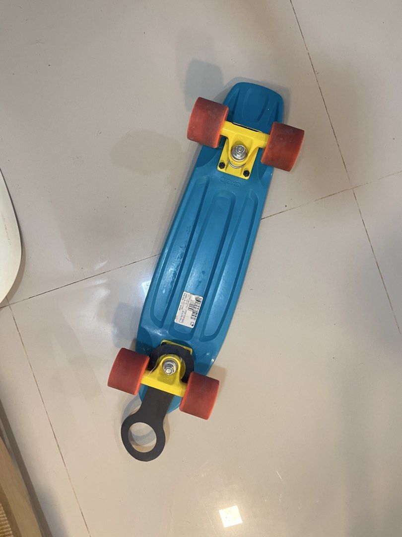 Oxelo Yamba Blue Corail Skateboard (Category: Skates, Rollerblades & Scooters) located in Los Banos. Submitted by reinabee88 (Listing ID 1467308831, Image 2). Description: - Brand/Model: Oxelo Yamba Blue Corail cruiser skateboard - Deck: Blue plastic with a textured top pattern - Hardware: Yellow trucks and smooth-rolling red wheels - Add-ons: Black tail guard installed near the rear truck - Condition: Lightly used, with model/barcode sticker int