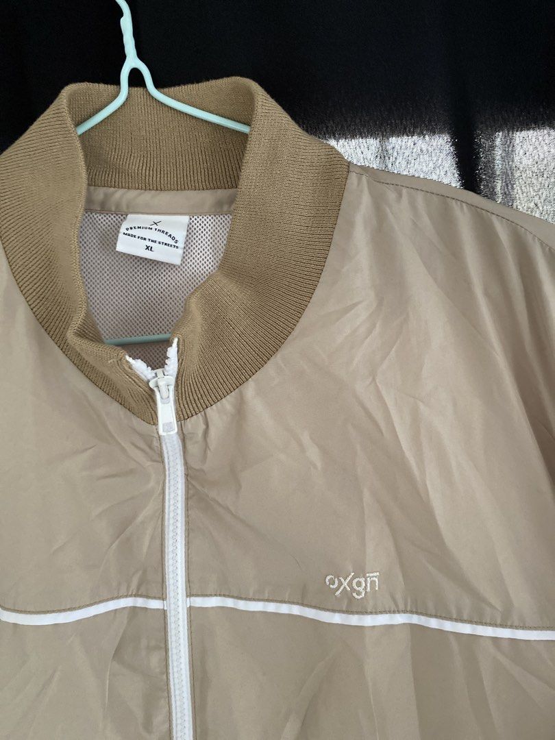 oxgn beige bomber jacket (Category: Coats, Jackets and Outerwear) located in Angono. Submitted by gunguny0gurt (Listing ID 1467182362, Image 2). Description: size: xl on tag - beige color with white stripe accents across chest and sleeves - details: ribbed knit collar, cuffs, and hem in darker tan, white front zipper, mesh inner lining, 2 front pockets - good as new! (used 2-3 times) loc: sampaloc, manila sf shouldered by buyer mop: gcash mod: jn