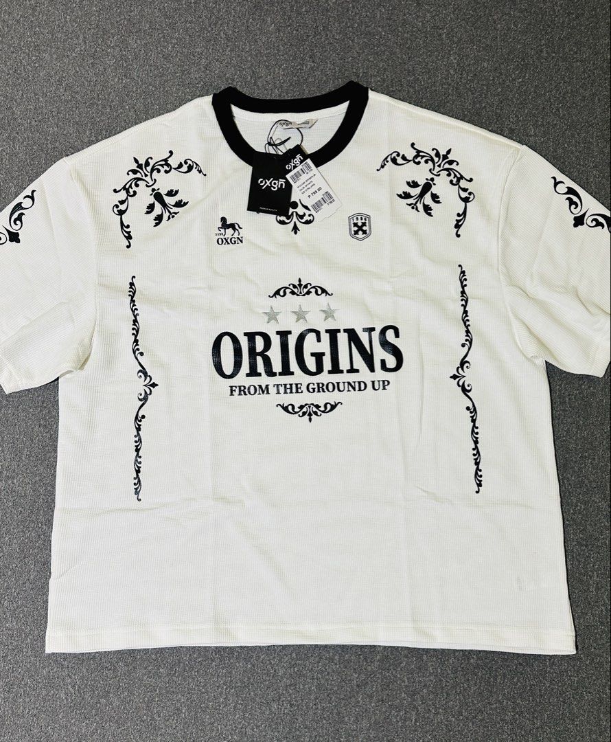 OXGN Oversized Shirts XL Size (Category: Shirts) located in Subic. Submitted by thrifty.finds024 (Listing ID 1467330785, Image 2). Description: - Brand: OXGN - Style: Oversized t-shirts - Color: Off-white - Size: Extra Large (XL) - Designs: Origins (baroque motifs/stars) and Motorcycle (Chase The Grind text) - Condition: Brand new with original tags - Retail Price: ₱799 each - Price: ₱450 for one / ₱800 for both.