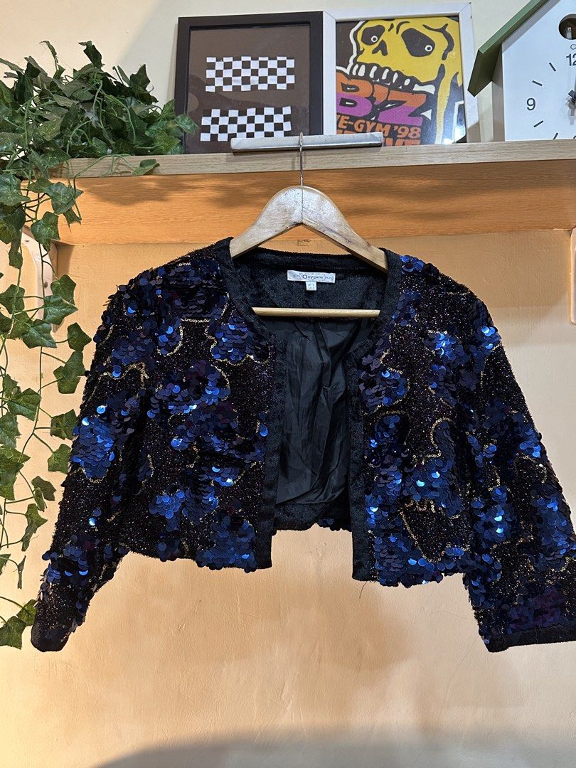 Oxygene Blue Sequin Jacket And Skirt Set (Category: Sets or Coordinates) located in Manila. Submitted by tenshiii185 (Listing ID 1467251405, Image 1). Description: - Brand: Oxygene - Item: Jacket and skirt coordinate set - Color/Design: Black base with striking blue sequins and gold outlining - Set Details: Matching cropped open jacket and high-waisted skirt - Interior: Fully lined for comfort - Size: UK S / EUR S - Condition: Great statement out
