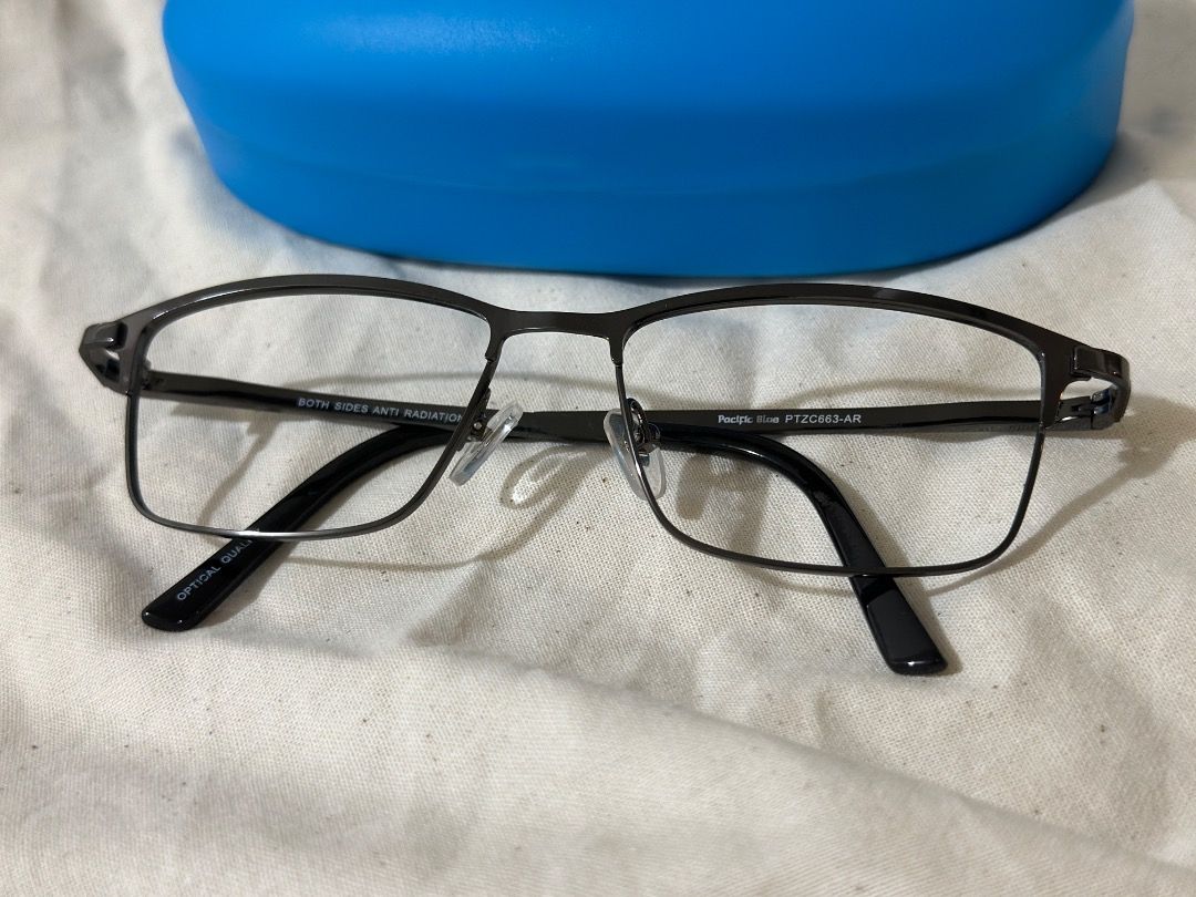 Pacific Blue Eyeglass Frames with Case and Spare Lenses (Category: Sunglasses & Eyewear) located in Mandaluyong City. Submitted by lovedbyjaaaam (Listing ID 1467277479, Image 2). Description: - Brand/Model: Pacific Blue PTZ0663-AR - Color: Dark gunmetal grey - Shape & Material: Rectangular metal frame with comfortable acetate temples - Fit: Standard nose pads attached - Inclusions: Matching bright blue hardshell case + extra clear demo/prescripti
