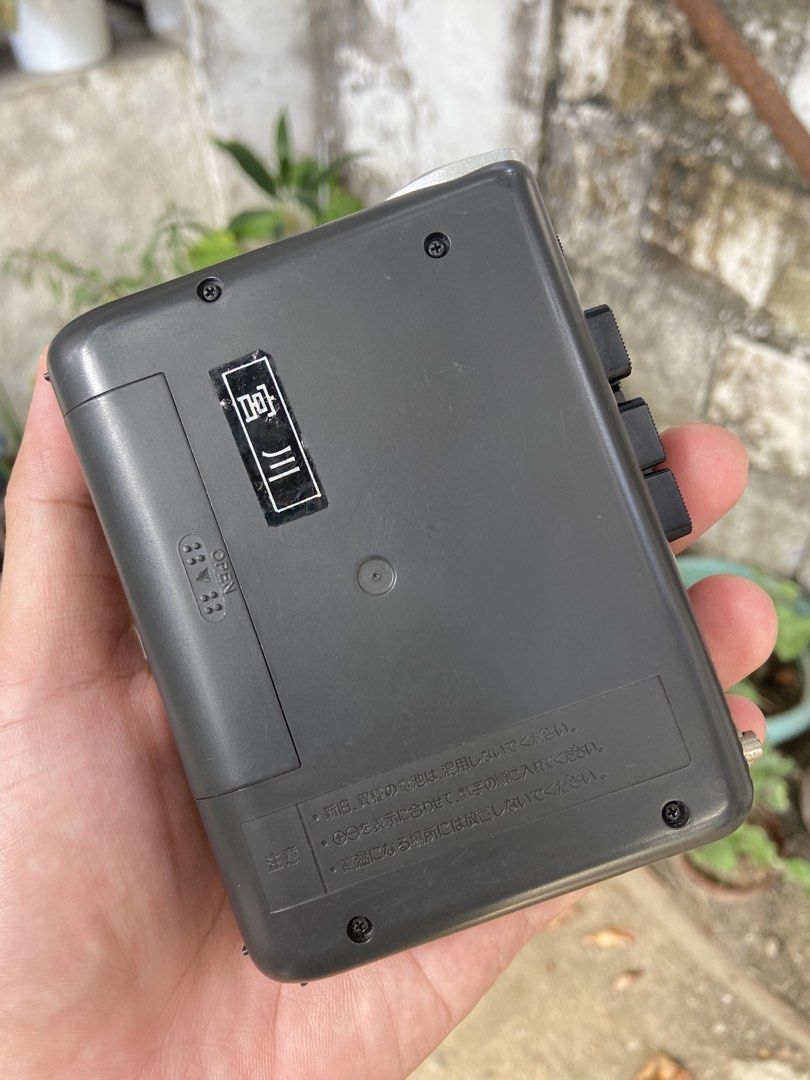Panasonic RQ-L25 Mini Cassette Recorder (Category: Portable Music Players) located in Malolos. Submitted by anthony_collectibles (Listing ID 1467304799, Image 2). Description: Good working condition - Model: Panasonic RQ-L25 Mini Cassette Recorder - Color: Classic grey with Japanese text label on the back - Controls: Playback speed control dial, record button, and standard side-mounted playback controls - Audio: Built-in front panel speaker - Pow