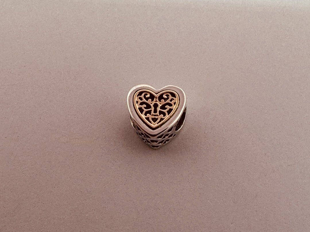 Pandora Locked Hearts Charm (791740) (Category: Charms) located in Cabanatuan. Submitted by water.withahintoflime (Listing ID 1467289891, Image 1). Description: Retired|Authentic Sterling silver | 14k gold openwork hearts 📍NOS|New Old Stock [May have some blemishes due age, handling and storage]. ✅ Packaging [box|bag|polishing cloth].