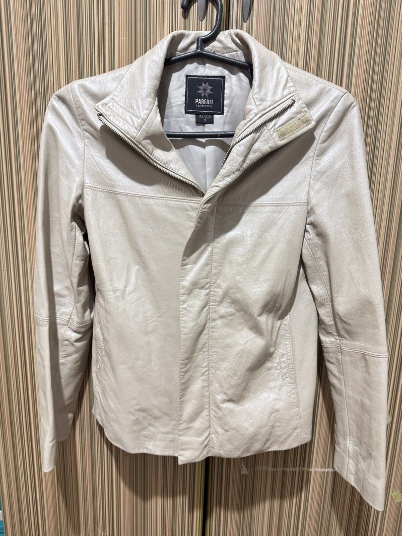 PARFAIT Leather Jacket Off-White Size S (Category: Coats, Jackets and Outerwear) located in Manila. Submitted by chie04_875 (Listing ID 1467190692, Image 2). Description: - Brand: PARFAIT - Style: Leather jacket - Color: Off-white / Cream - Size: S - Design: High collar, front zip with snap flap placket, horizontal seam details, and paneled construction - Fit: Great piece for layering.