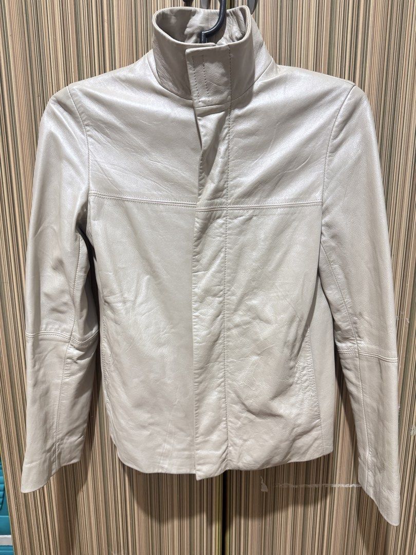 PARFAIT Leather Jacket Off-White Size S (Category: Coats, Jackets and Outerwear) located in Manila. Submitted by chie04_875 (Listing ID 1467190692, Image 1). Description: - Brand: PARFAIT - Style: Leather jacket - Color: Off-white / Cream - Size: S - Design: High collar, front zip with snap flap placket, horizontal seam details, and paneled construction - Fit: Great piece for layering.