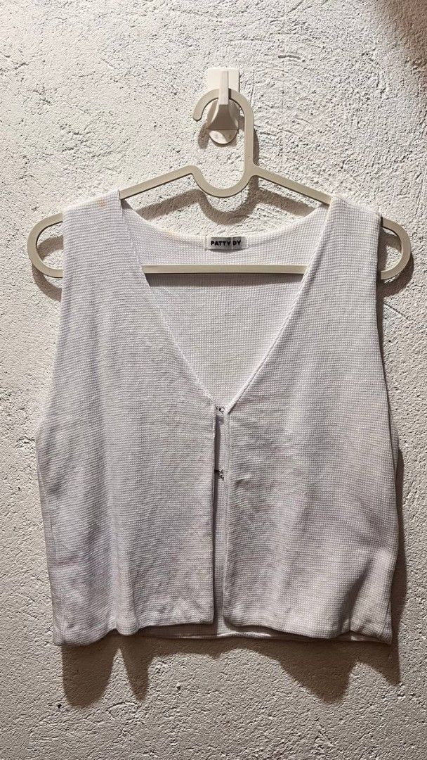 Patty Dy White Waffle Knit Vest (Category: Sleeveless) located in Imus. Submitted by thriftipop (Listing ID 1467176143, Image 1). Description: - Brand: Patty Dy - Style: V-neck, sleeveless, cropped waffle knit vest - Color: Clean white - Closure: Front metal hooks and eyes - Details: Textured fabric throughout - Versatility: Easy to pair with tees or wear solo ***May stains need lang labhan**** 🍓 All pictures are actual 🍓 Manage your own expect