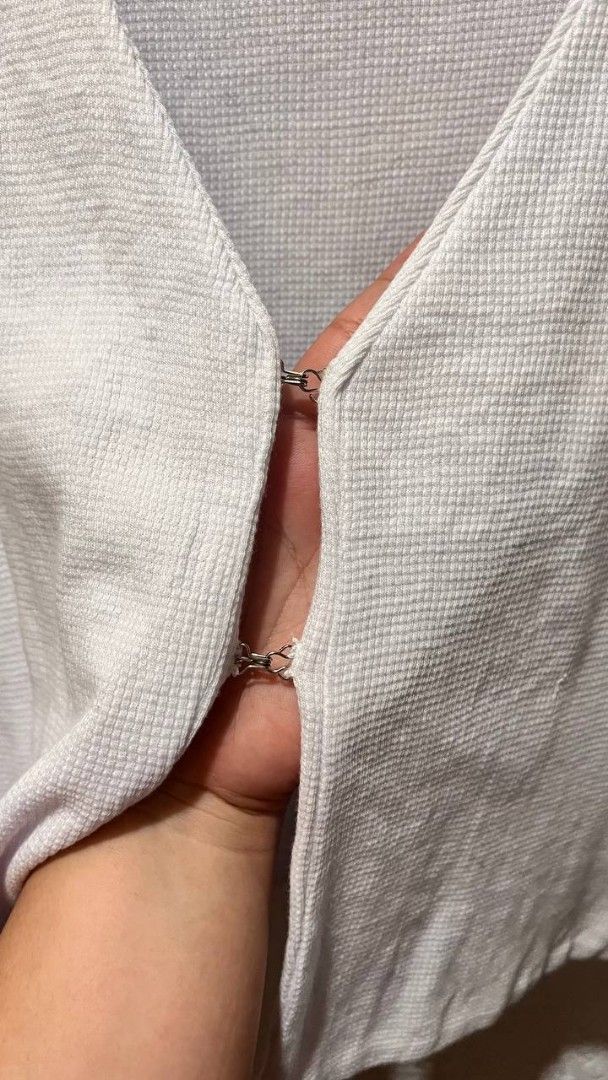 Patty Dy White Waffle Knit Vest (Category: Sleeveless) located in Imus. Submitted by thriftipop (Listing ID 1467176143, Image 2). Description: - Brand: Patty Dy - Style: V-neck, sleeveless, cropped waffle knit vest - Color: Clean white - Closure: Front metal hooks and eyes - Details: Textured fabric throughout - Versatility: Easy to pair with tees or wear solo ***May stains need lang labhan**** 🍓 All pictures are actual 🍓 Manage your own expect