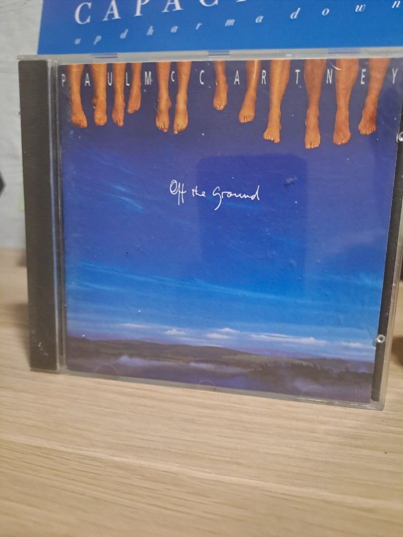 Paul McCartney Off the Ground Music CD (Category: CDs & DVDs) located in Las Pinas. Submitted by cobieshop (Listing ID 1467330537, Image 1). Description: - Artist & Album: Paul McCartney - Off the Ground - Format: Original audio CD in standard jewel case - Artwork: Classic blue cover with feet lined up on the left - Condition: Plastic case is fully intact with minor shelf wear on edges - Shipping: Packed securely for safe delivery across the PH -