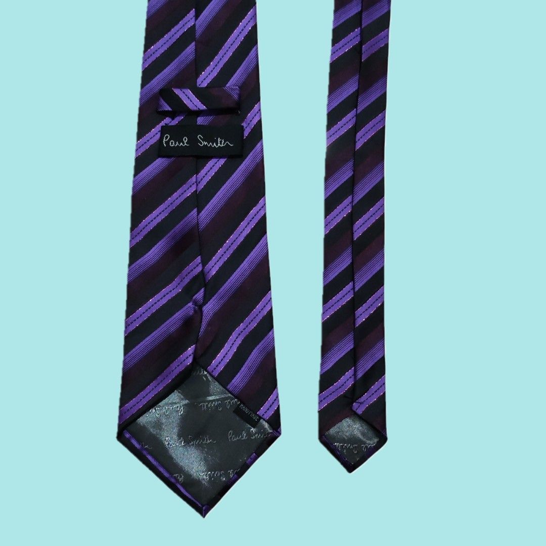 Paul Smith Purple Striped Silk Necktie (Category: Ties) located in Tarlac. Submitted by senkustuff (Listing ID 1467305337, Image 3). Description: - Brand: Paul Smith - Material: High-quality silk with subtle metallic threading - Design: Striking purple and black stripes - Details: Standard width blade, clean lining, and signature branding label on the back - Condition: Great pre-owned condition - Style: Ideal for business meetings, formal events,