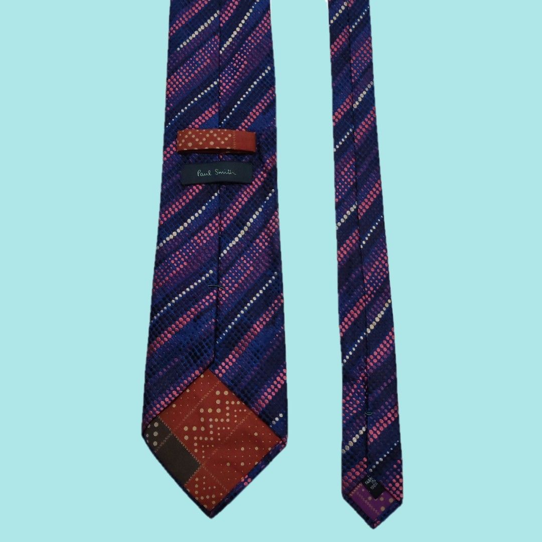 Paul Smith Silk Necktie (Category: Ties) located in Tarlac. Submitted by senkustuff (Listing ID 1467305019, Image 3). Description: - Brand: Paul Smith - Origin: Made in Italy - Material: 100% Silk - Design: Blue base with diagonal stripes of pink and white polka dots - Feature: Signature patterned tipping lining inside the tail - Width: Classic professional width.