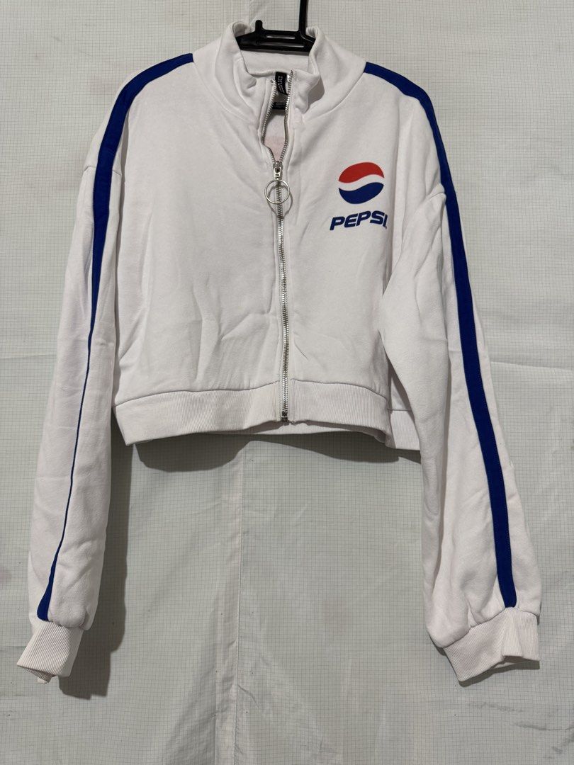 pepsi white crop track jacket (Category: Coats, Jackets and Outerwear) located in Quezon City. Submitted by riexomt (Listing ID 1467271958, Image 1). Description: - white cropped track jacket pepsi h&m collab - blue stripe detail on both sleeves - japanese lettering at back (bought in japan) - fill zip front with circle ring zipper - high collar neckline with ribbed cuffs - for casual streetwear and y2k!.