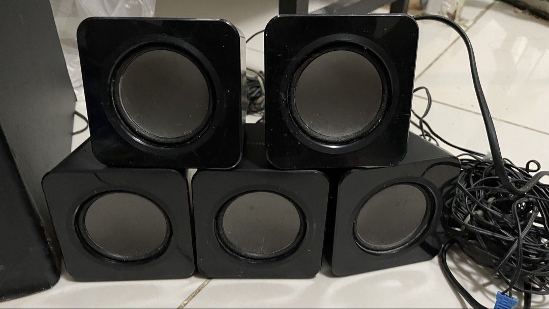 Philips Home Theater System with DVD Player and Speakers (Category: Soundbars, Speakers & Amplifiers) located in General Trias. Submitted by ashi_kt0 (Listing ID 1467211313, Image 3). Description: - Complete Philips home theater system: main DVD player, large subwoofer, and 5 satellite speakers - Sleek black finish across all matching components - Includes plenty of attached wiring for easy setup - Tested and working: powers on and plays discs sm